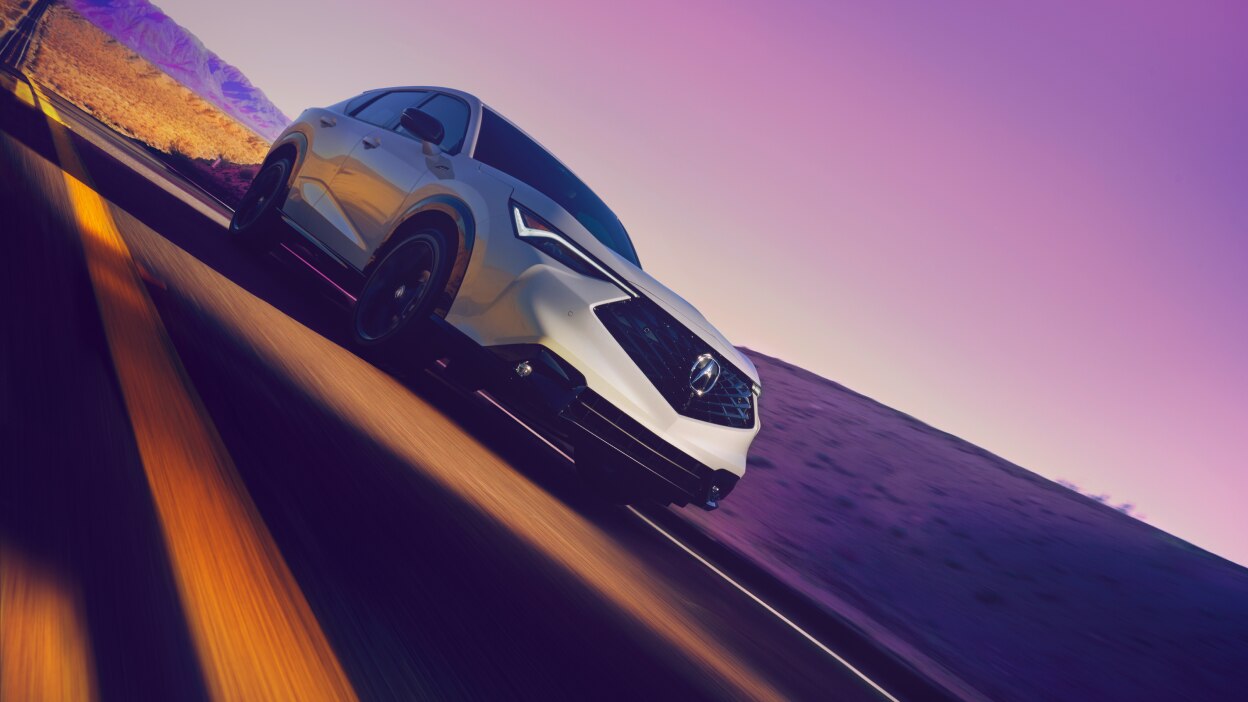 Angled image of a grey Acura ADX on a highway. 