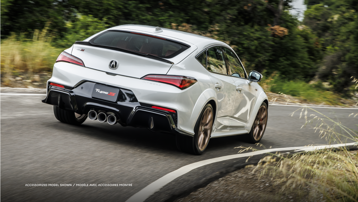 Rear-view of a white ntegra driving on a forest road.