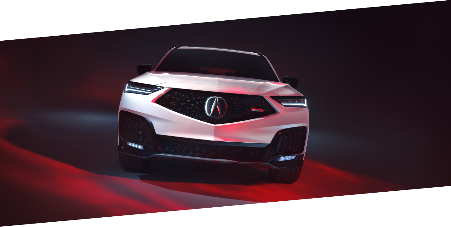 Plan avant d’un MDX Type S Ultra blanc dans un studio éclairé par une lumière rouge.