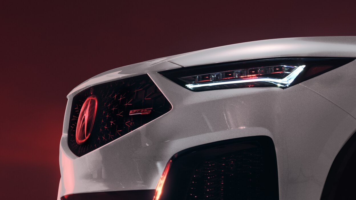 A grey MDX parked on a city street.