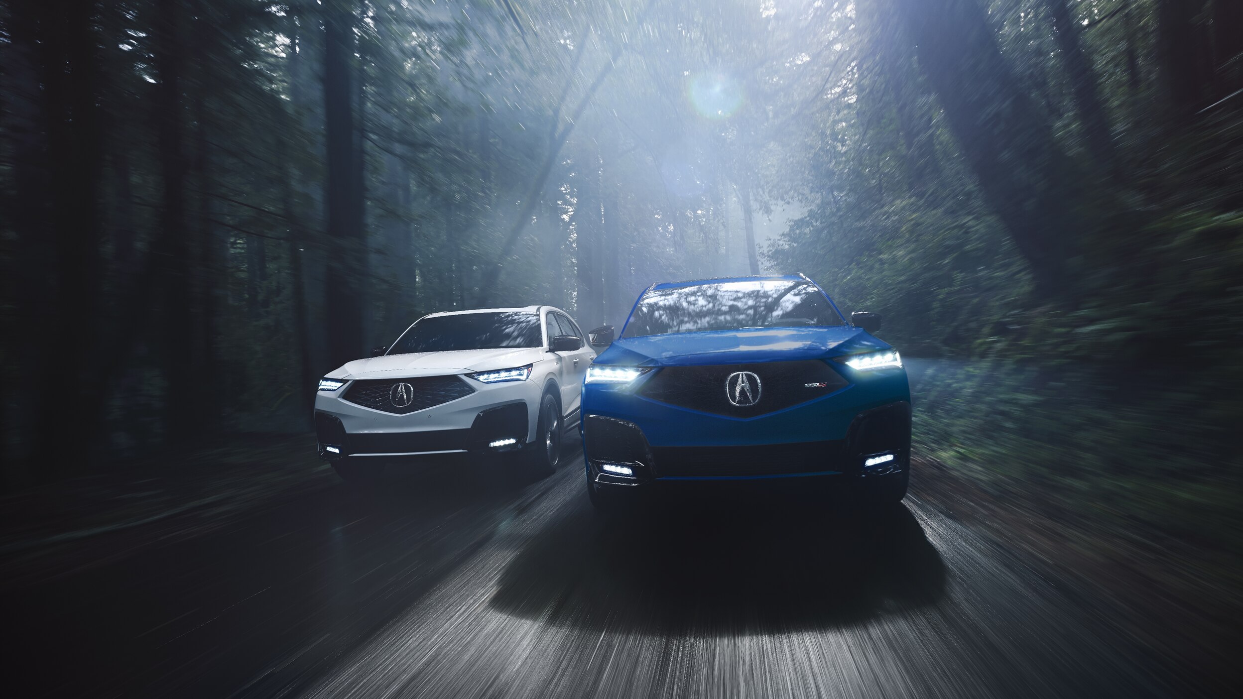 A red MDX parked inside a bright, spacious warehouse.