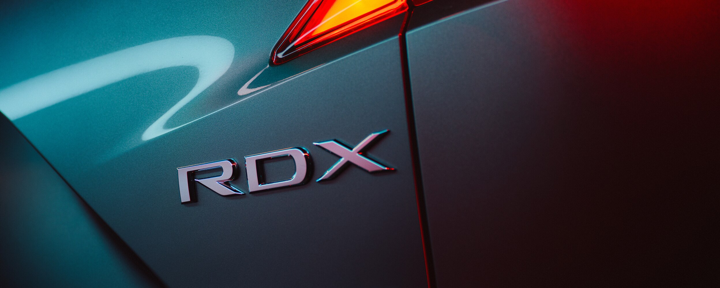 Closeup of RDX and SH-AWD badging on grey RDX.