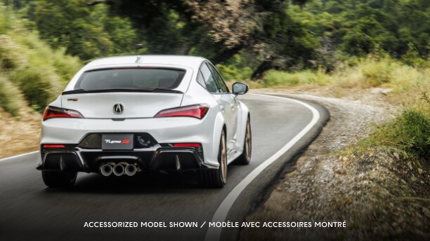 A white Integra Type S driving on a highway.