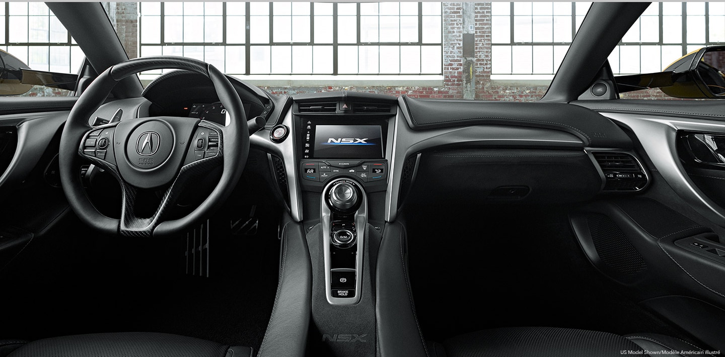 The interior of an Acura's cockpit from the backseat. / Vue du cockpit d’une Acura à partir de la banquette arrière.