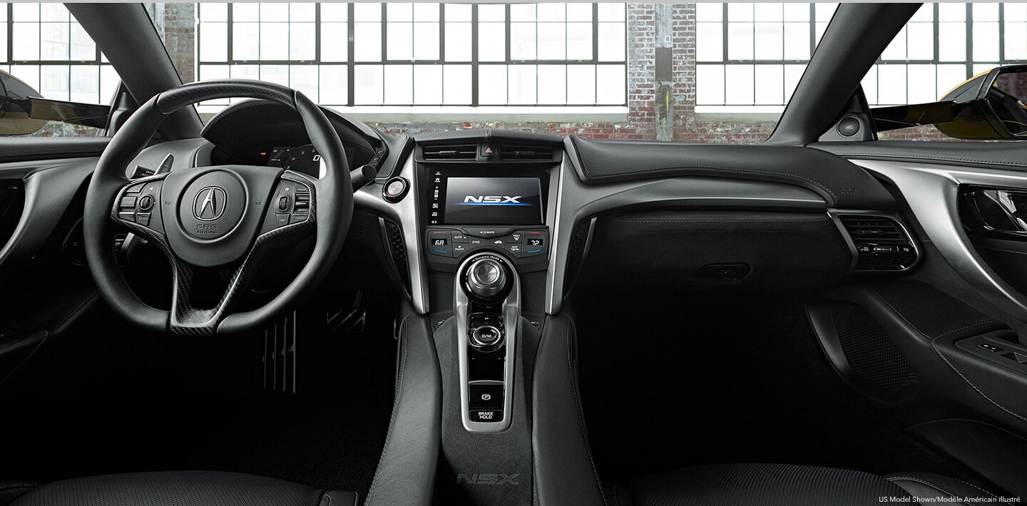 The interior of an Acura's cockpit from the backseat. / Vue du cockpit d’une Acura à partir de la banquette arrière.