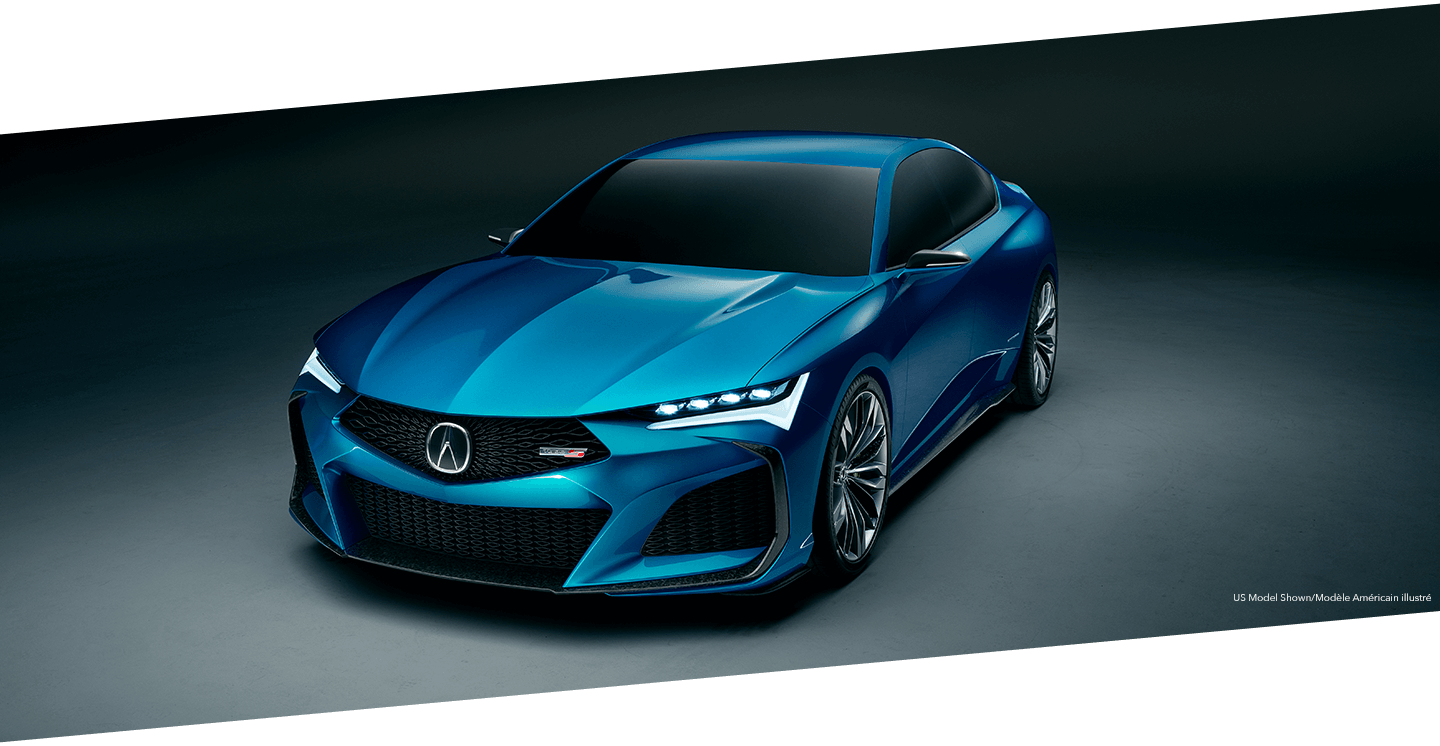 Front angled view of a blue Acura TLX Type S parked in a darkened grey space with a subtle spotlight illuminating it from above. Vue de face et en angle d’une Acura TLX Type S bleue stationnée dans un espace gris foncé, avec une subtile lumière qui l’illumine en surplomb.