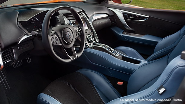 Interior front cabin in an Acura NSX featuring blue and black leather seating. Habitacle avant d’une Acura NSX avec sièges en cuir bleu et noir.